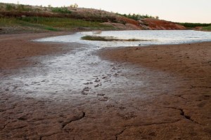A view of the dry bed of a reservoir in Texas. Records show that environmental officials have granted more than 50 aquifer exemptions for waste disposal in that state. Courtesy of ProPublica