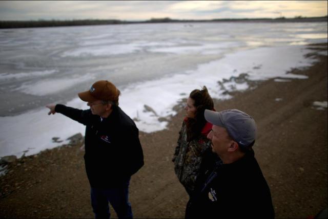 Mayor Rick Norby (right) and two staff members inspect one of Sidney's wastewater lagoons, which needs to be replaced by modern treatment plant. Photo: David Gilkey, NPR